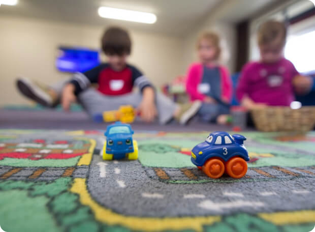 kids playing with cars - blurred background