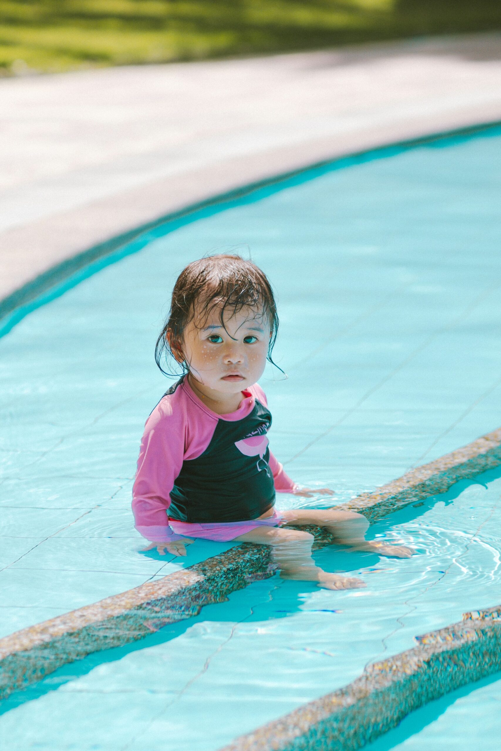 Toddler girl in a pool